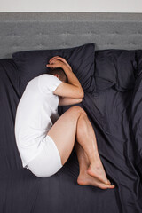 Handsome young man sleeping comfortably on the bed at night in his bedroom wearing pajamas....