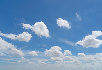 Fototapeta premium Clear blue sky with white fluffy clouds at noon. Day time. Abstract nature landscape background.
