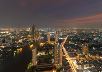 Fototapeta na wymiar Aerial view of Bangkok Downtown Skyline, Thailand. Financial district and business centers in smart urban city in Asia. Skyscraper and high-rise buildings with Chao Phraya River.