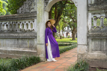 Fototapeta na wymiar Portrait of Asian Vietnamese woman girl in local temple traveling in Hanoi urban city town, Vietnam. People lifestyle.