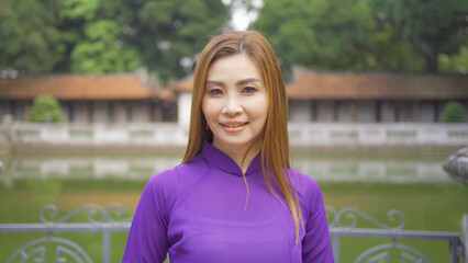 Portrait of Asian Vietnamese woman girl in local temple traveling in Hanoi urban city town, Vietnam. People lifestyle.