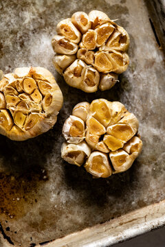 Home baked garlic cloves on a baking tray