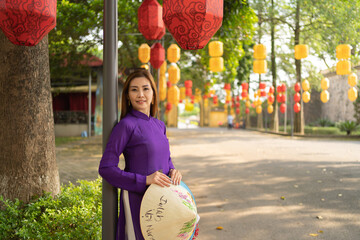 Portrait of Asian Vietnamese woman girl in local temple with light lanterns festival traveling in...