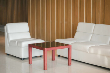 close up on bright sofa accent and table in the lobby without people