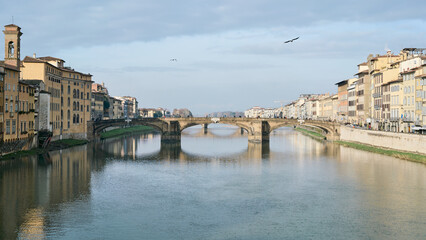 Fototapeta na wymiar Morning view of river Arno and Ponte Santa Trinita from Ponte Vecchio in Florence, Italy