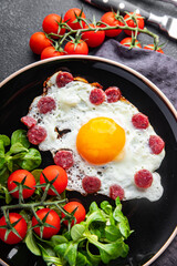 fried eggs vegetables, sausages breakfast fresh healthy meal food snack on the table copy space food background rustic top view