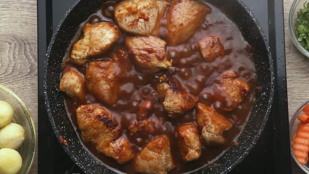 cooking meat burgundy in red tomato sauce