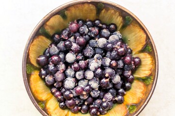Frozen black currant in a cup
