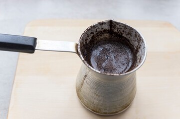 Freshly brewed coffee in old cezve