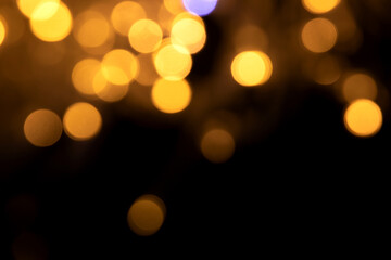 Abstract background of blurred yellow lights for design. Lights bokeh dis focus. Christmas background, copy space