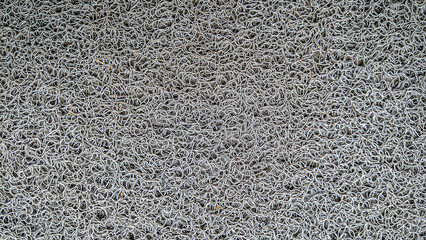 Foot mat rug texture with rubber material, patterned doormat rug background.