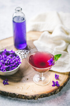 Cocktail with Violet Syrup and edible flowers