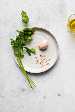 Parsley, garlic and pink salt on plate, ready to prepare a seasoning