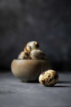 Quail eggs on dark background