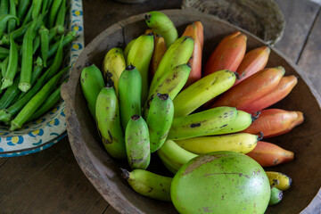 Bunches of banana in rustic wooden bowls for sale after harvest in a popular economy farm. Sao Paulo state, Brazil
