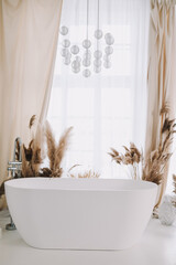 Modern white bathroom. White bath in a room with white walls. Interior design