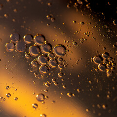 Oil in water, abstract background in golden and blue color tones