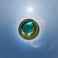 green tiny planet in blue sky with beautiful clouds. Transformation of spherical panorama 360...