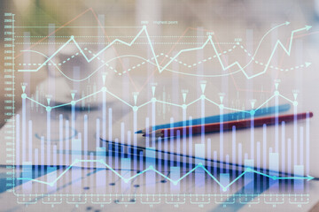 Forex graph hologram on table with computer background. Double exposure. Concept of financial markets.