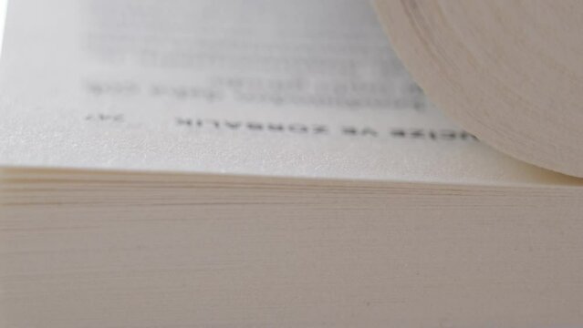 Macro shot of flipping white pages of a book