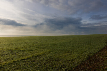 Beautiful autumn landscape in a foggy haze. Dramatic sky with beautiful clouds.