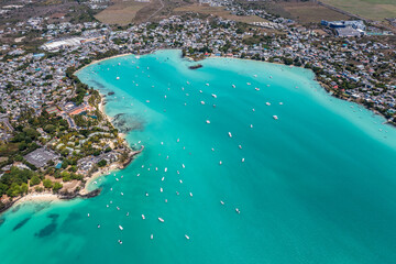 Grand Baie, Mauritius - aerial landscape view of Grand Bay, the infrastructure and buildings along the coastline and many boats on water