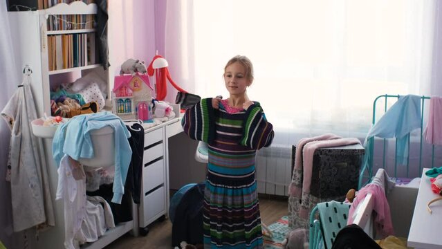 Little Girl Trying On Dress Of Mom While Home Alone In Her Messy Room, Slow Motion