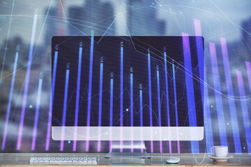 Stock market graph on background with desk and personal computer. Multi exposure. Concept of financial analysis.