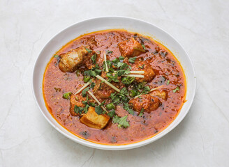 chicken achari korma served in plate isolated on table top view of indian and pakistani spicy food