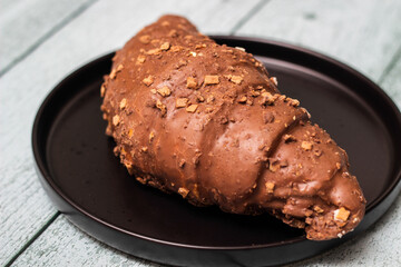 Freshly chocolate croissant on plate