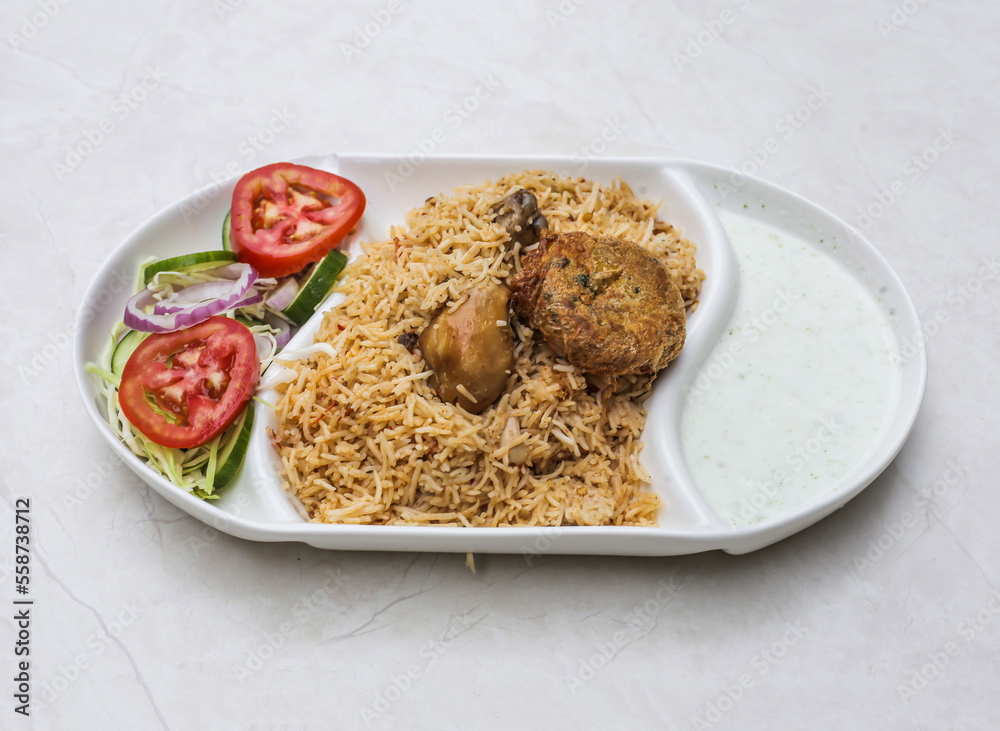 Wall mural Spicy chicken pulao or biryani with raita and salad served in plate isolated on table top view of indian and pakistani spicy food