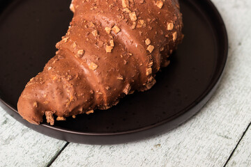 Freshly chocolate croissant on plate
