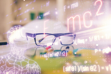 Formulas drawing with glasses on the table background. Concept of science. Double exposure.