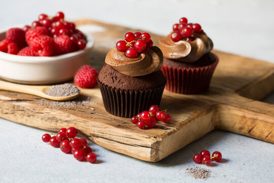 Chocolate cupcake with frosting and red fruits