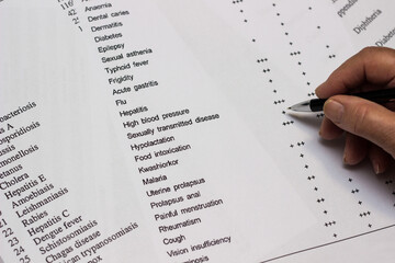 Close up of a senior woman hand medical history questionnaire