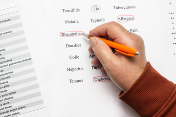 Close up of a senior woman hand medical history questionnaire