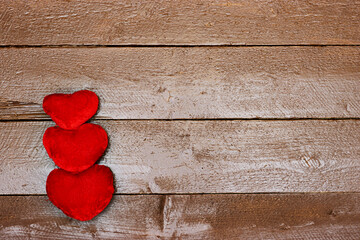 Fototapeta premium three heart isolated on wooden table