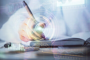 International business hologram over hands taking notes background. Concept of success. Multi exposure