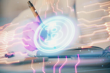 Cryptocurrency hologram over woman's hands writing background. Concept of blockchain. Double exposure