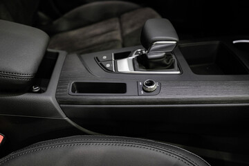 Fototapeta na wymiar Automatic transmission selector with leather in the interior of a modern expensive car