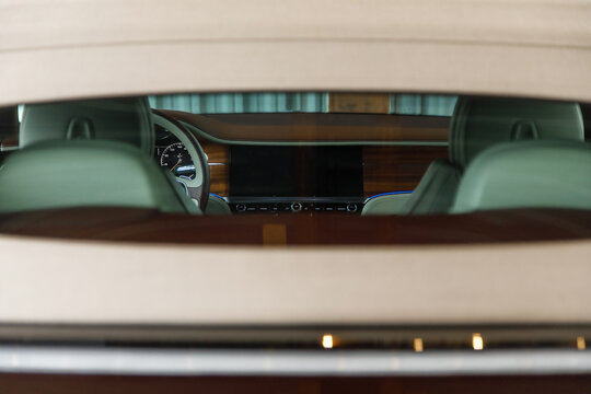 photo of the light interior of a luxury sports car through the rear window