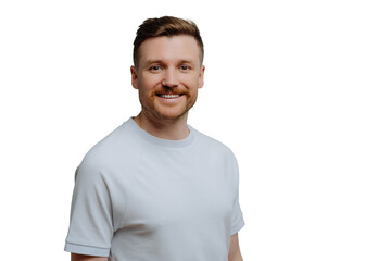 Young positive unshaven guy in white shirt has happy facial expression while looking at camera, handsome hairy man posing against blue studio background. Positive emotions concept