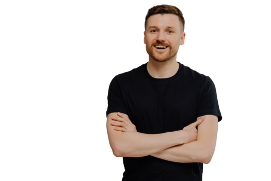 Good looking attractive unshaven guy in casual wear keeping arms crossed and smiling at camera while standing against gray background, young man demonstrating positivity while posing in studio - Powered by Adobe
