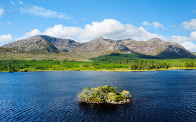 View over Lough Inagh in Connemara, Ireland, shows the prehistoric crannog, a man-made island, with...
