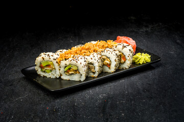 sushi on a black plate