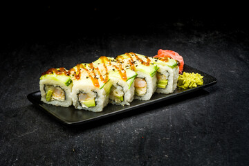 sushi on a black plate