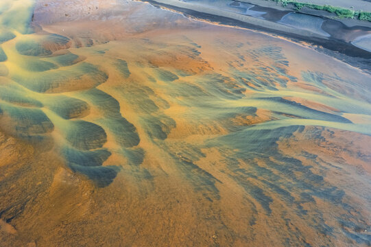 Aerial view of abstract water formation along the coast at Floi Nature Reserve, Iceland.