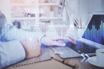 Multi exposure of stock market chart with man working on computer on background. Concept of financial analysis.
