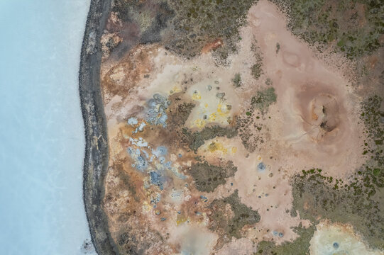 Aerial view of a coastline along the lakefront at Gunnuhver Hot Springs (Geo Thermal Hot Spring), Grindav&iacute;k, Iceland.