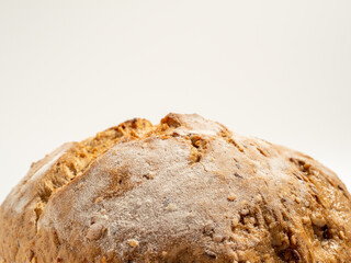 Dark bread on a white background. Round Bread with grains.